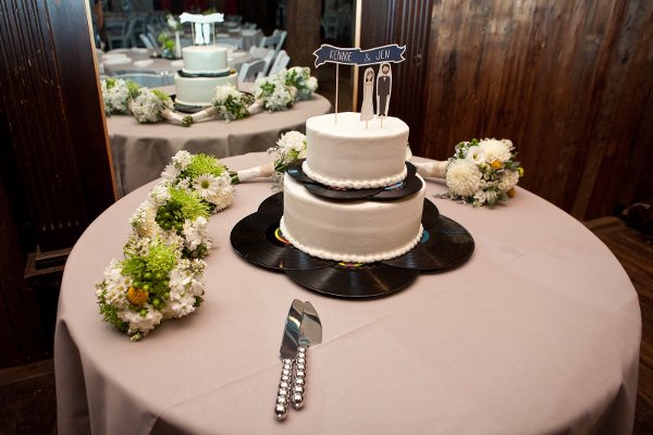 a wedding cake with vintage vinyl album stand