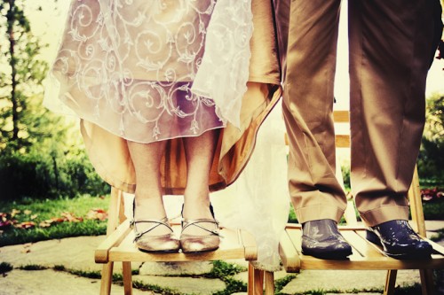 bride and groom standing on chairs outdoor diy wedding