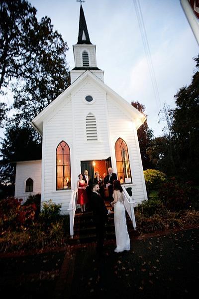 bride and groom in front of oaks pioneer church