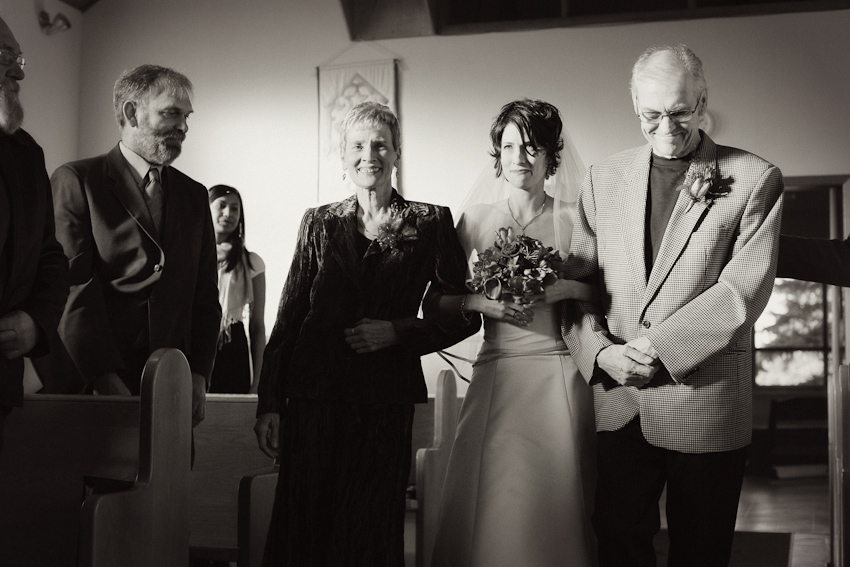 bride escorted down the aisle church wedding