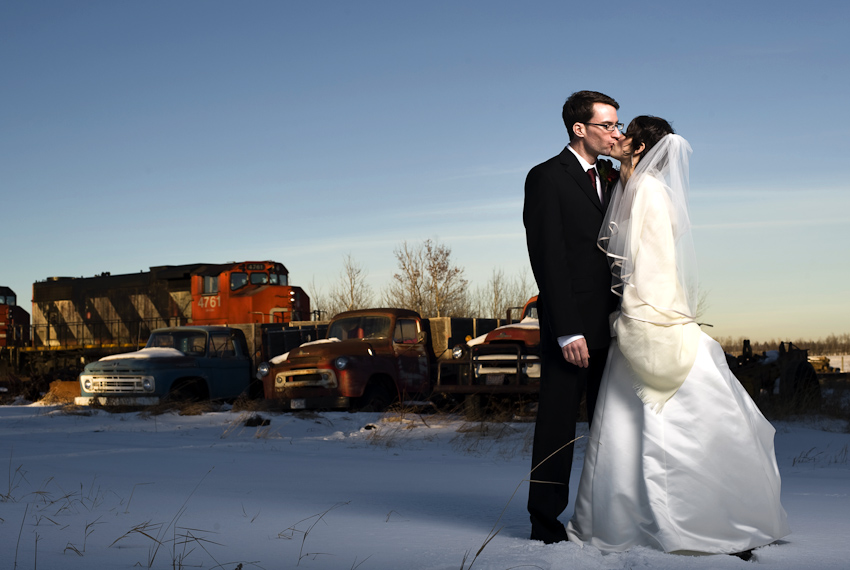 bride and groom in front of CN train