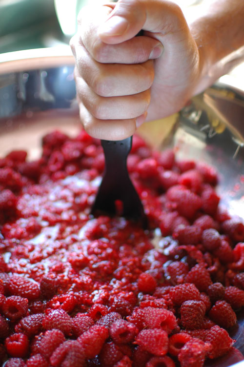 mashing raspberries