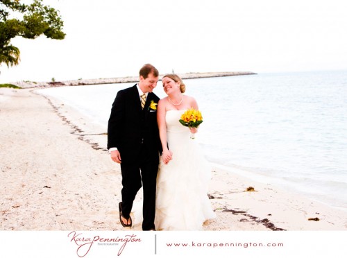 bride and groom walking on the beach