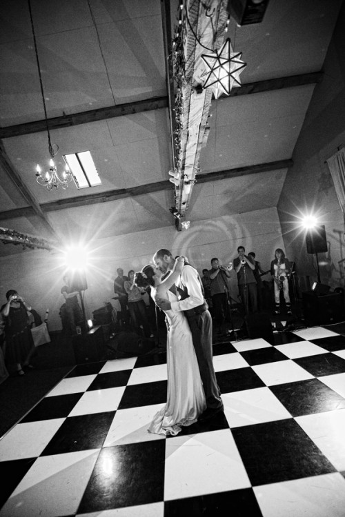 bride and groom dancing in a barn