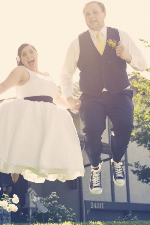 bride and groom jumping