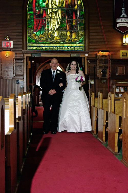 father walking down the aisle with bride