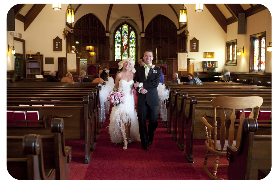 bride and groom walking down the aisle in church