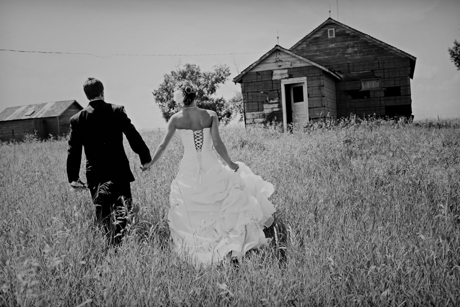 bride and groom in a farm field