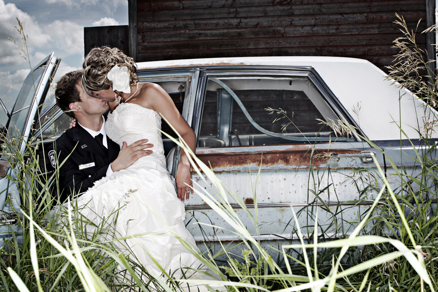 bride and groom in abandoned car