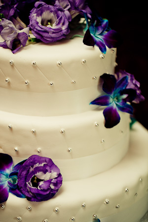 wedding cake with purple flowers