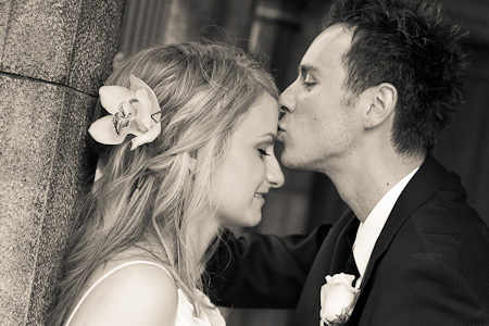 groom kissing bride's forehead