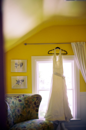 wedding dress hanging in window