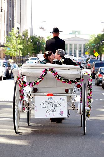 bride and groom in horse drawn carriage