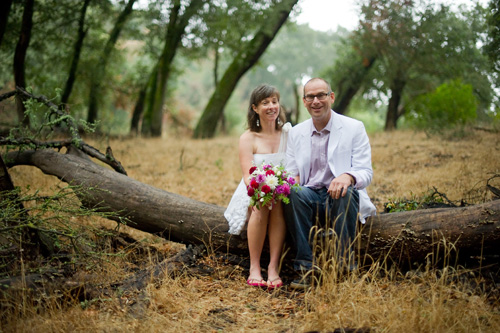 couple sitting on tree stump