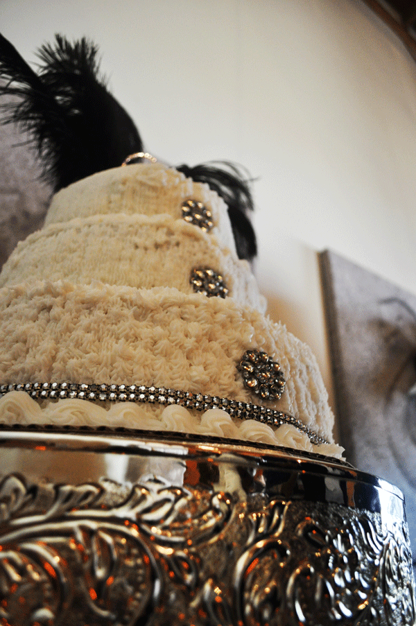 wedding cake with jewels and black feathers