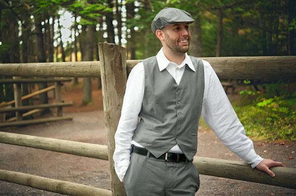 groom in grey vest and cap