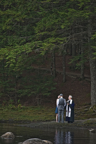 Bride and groom exchanging vows by the river