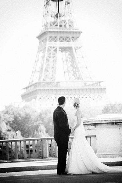 bride and groom in front of eiffel tower