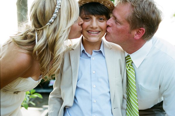 bride and groom kissing son