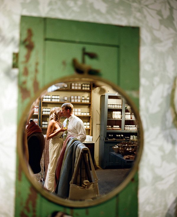 bride and groom kissing in mirror