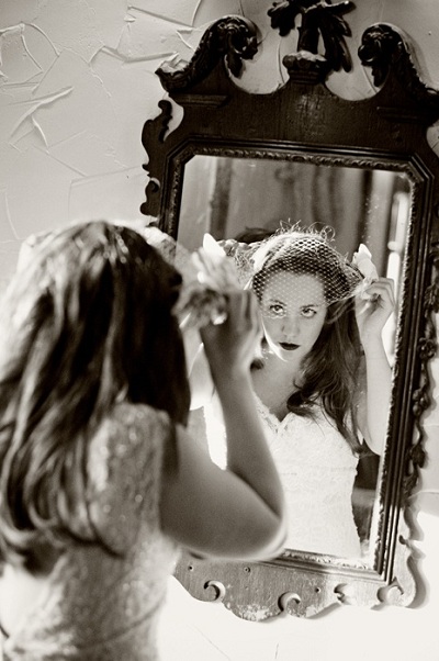 bride's reflection in antique mirror