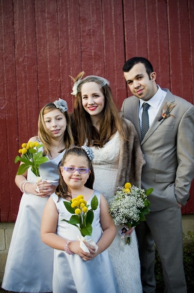 bride and groom with flower girls