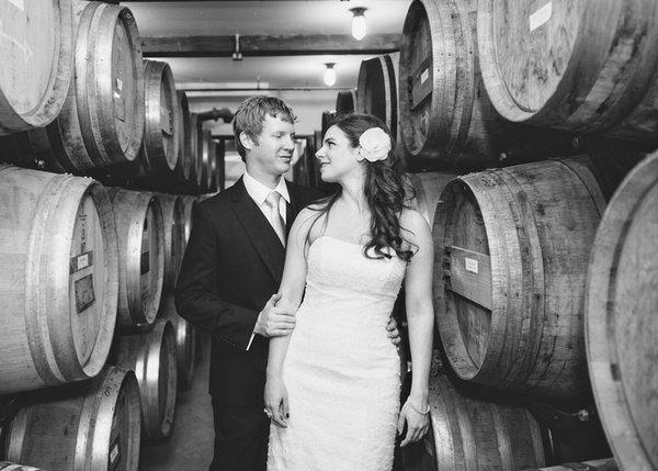 wedding portrait among wine barrels