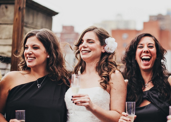 bride and bridesmaids drinking champagne