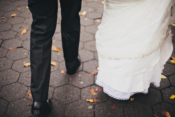 bride and groom walking through central park