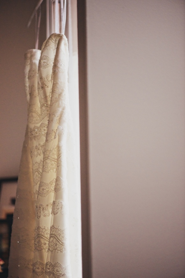 wedding dress hanging in window