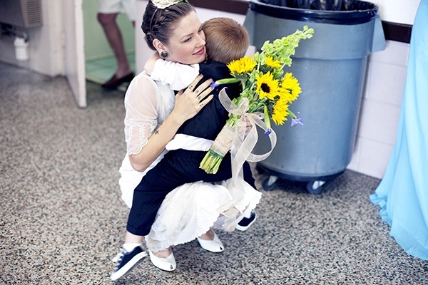 bride and ring bearer hug