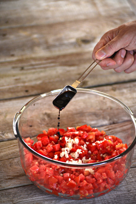 Adding the basalmic vinegar - making bruschetta