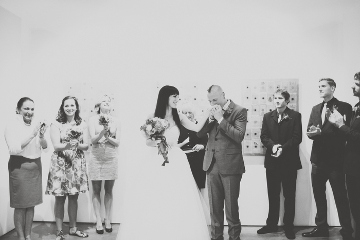 groom kissing bride's hand