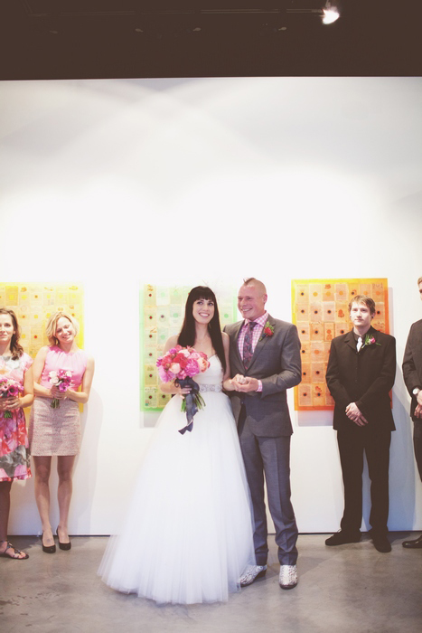 bride and groom facing wedding guests