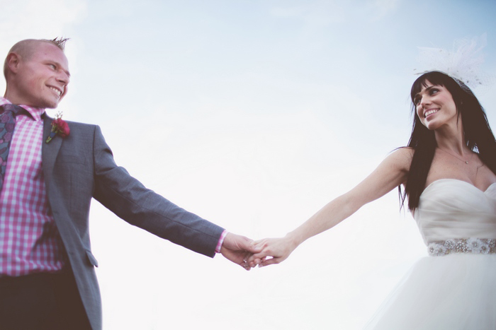 bride and groom holding hands