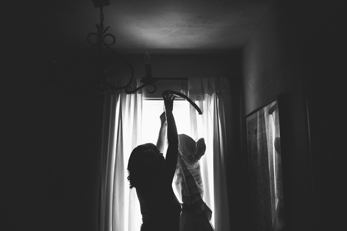 black and white photo of bride with her wedding dress