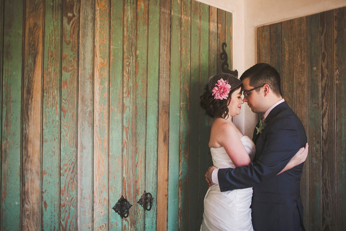 bride and groom portrait in front of green wooden door