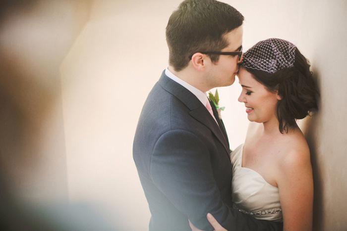 groom kissing bride's forehead