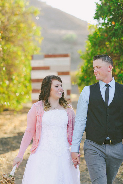 bride and groom walking away from ceremony site