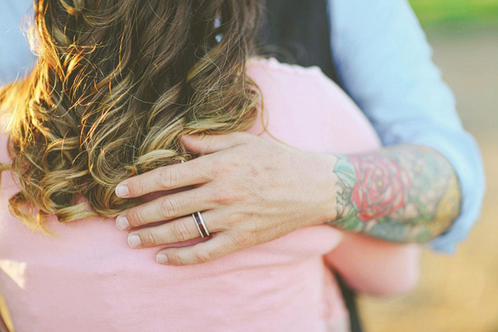 tattooed groom hugging bride