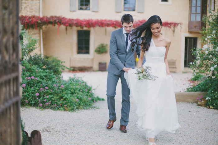 groom helping bride with her dress