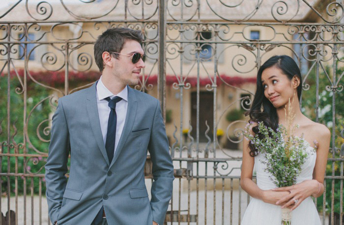 bride and groom in front of country house