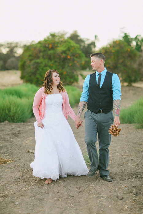 bride and groom walking in orange grove