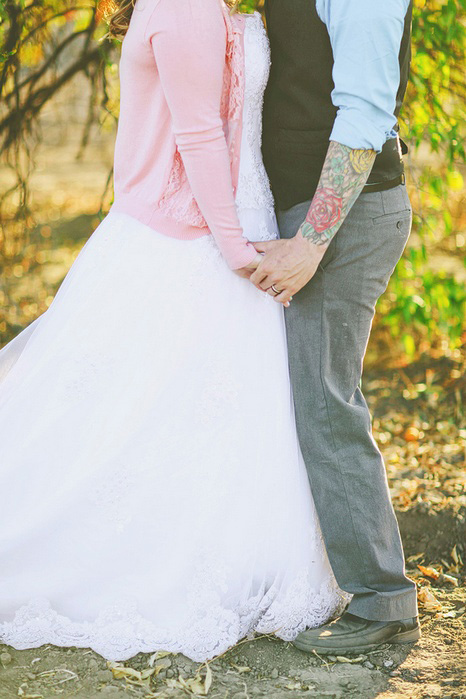 bride with pink cardigan and groom with arm tattoos