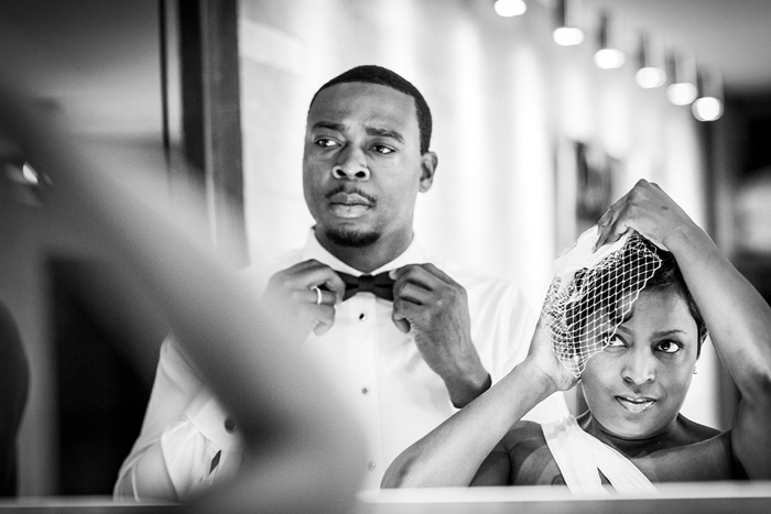 groom adjusting bow tie