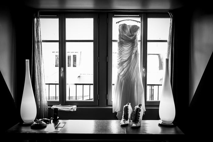 wedding dress hanging in window