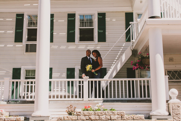 bride and groom on the porch of the emerson inn