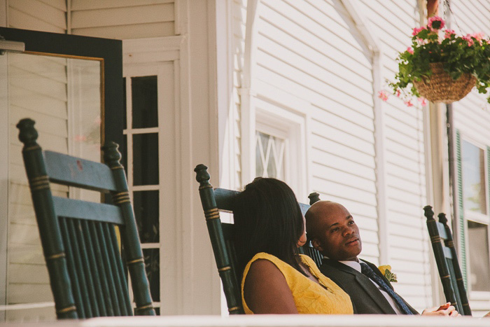 bride and groom on the porch of the emerson inn