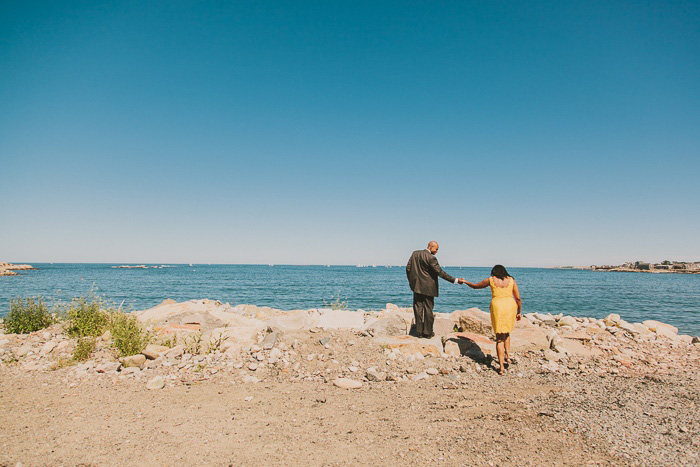 bride and groom walking towards the sea