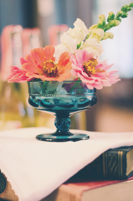 pink flowers in blue glass vase